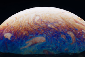 Vivid, swirling patterns in blue, orange, and white resembling a, a Background Photo by Ales Munt