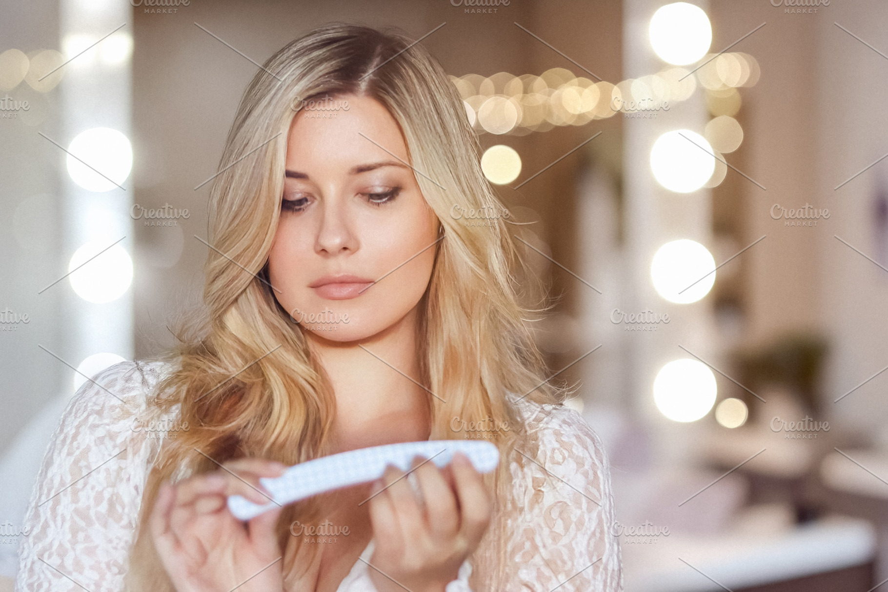 Young woman doing self care manicure, using nail file for beauty, a Person Photo by Studio ANNA