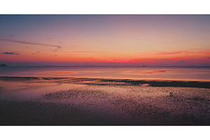 Colorful sunset reflecting on wet, a Nature Photo by Goinyk