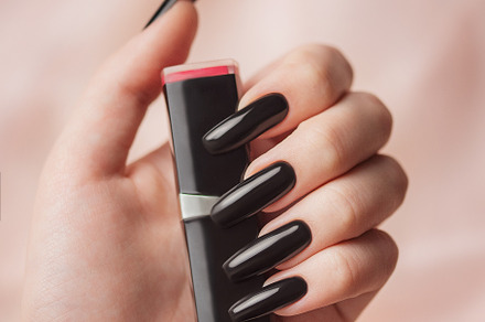 The hand of a young girl with a bright black manicure on her nai, a Beauty & Fashion Photo by Olena Rudo