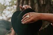 Woman with hands on her hat, a Person Photo by Wild Wander Collective (Thumbnail 2 of 2)