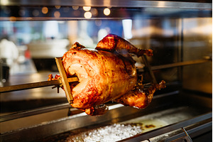 Whole roasted chicken turning on, a Food & Drink Photo by HalfPoint