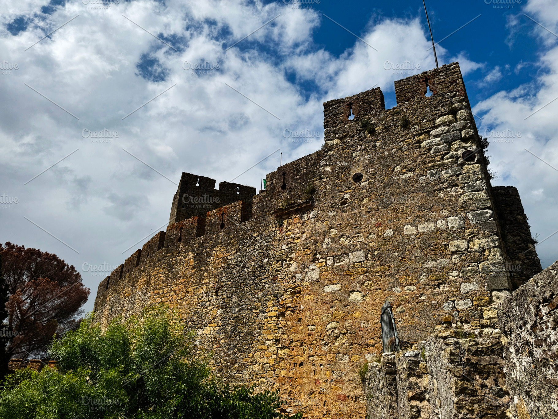 Historic Tomar castle with medieval architecture under a dramatic sky in Portug, a Photo by AS photostudio