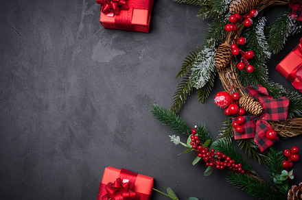 Christmas wreaths, fir branches and gifts on a black background., a Holiday Photo by ndanko