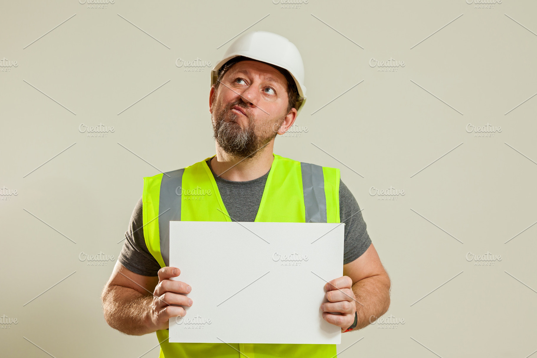 worker in a vest and white helmet, a Person Photo by Photostock