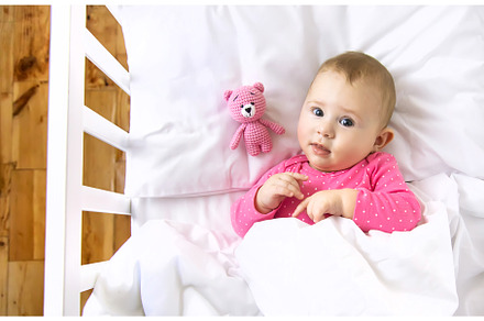 Baby toddler plays in the crib, a Person Photo by yanadjana