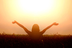 Happy girl lift her hands to the sky