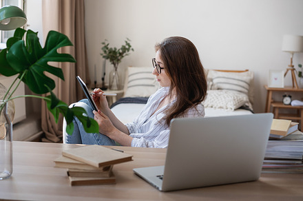 Young woman working at home, a Photo by Olezzo