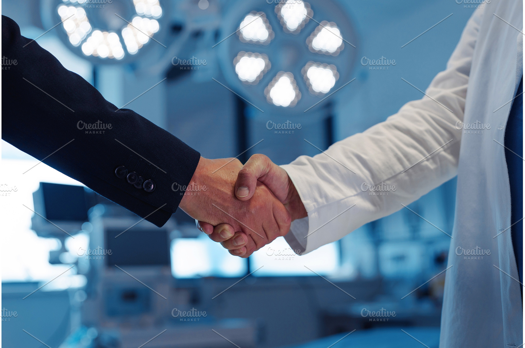 Hospital business handshake in, a Business Photo by HalfPoint