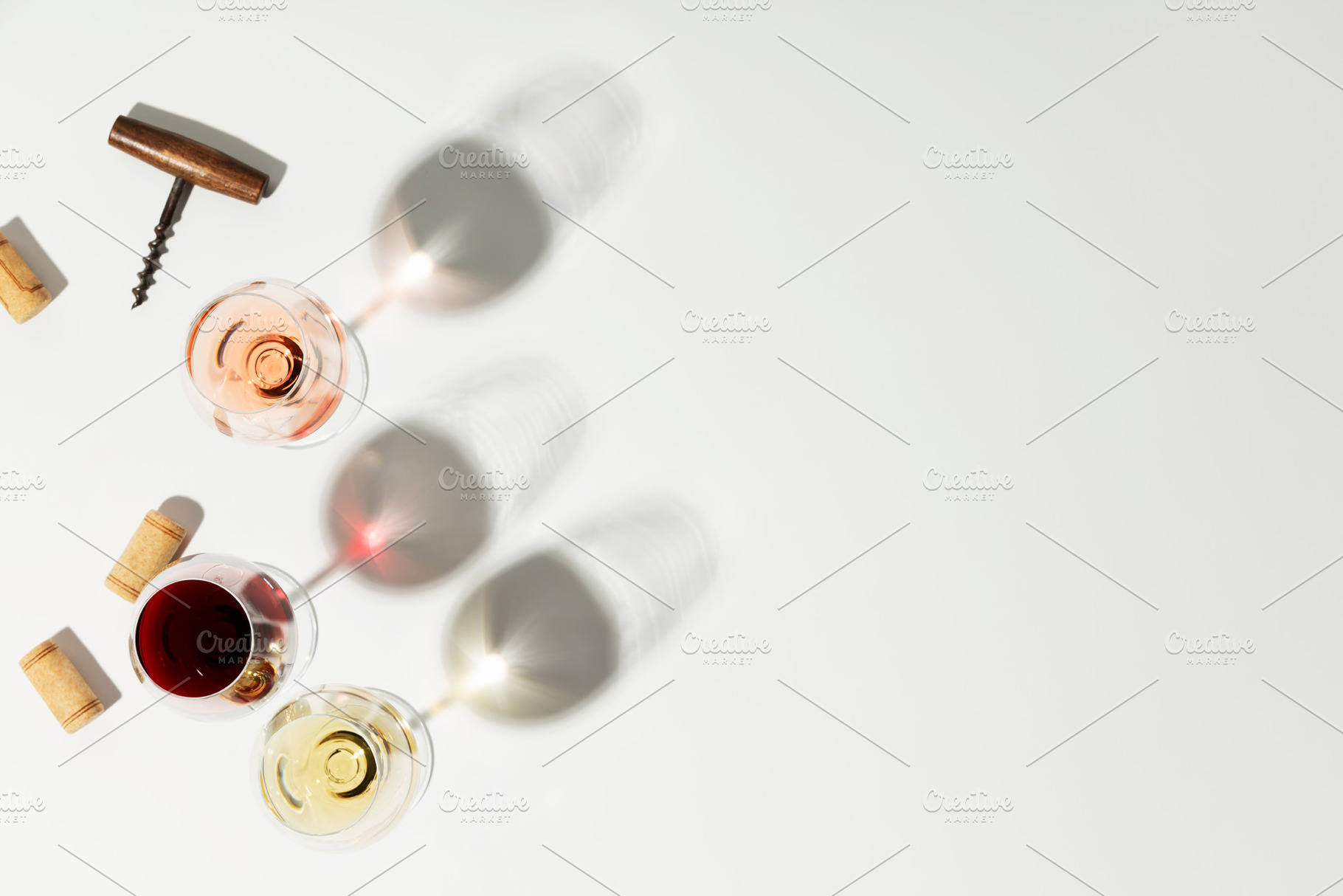 Flat-lay of red, rose and white wine in glasses on white backgro, a Food & Drink Photo by Natalia Klenova's Shop