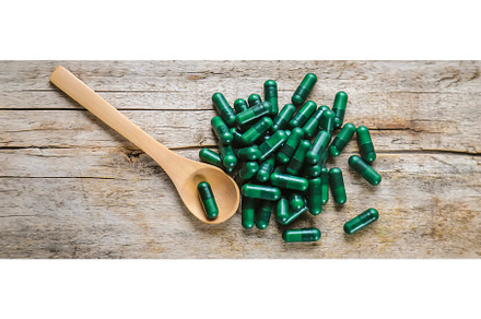 Green capsules, herbal medicines, a Health & Medical Photo by yanadjana