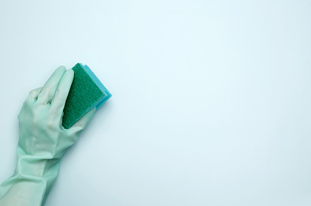 House cleaning. Womans hand in rubber glove holds dishwashing sponge, a Photo by matucha