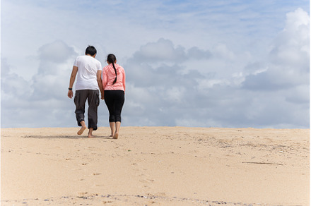 A couple is walking in desert