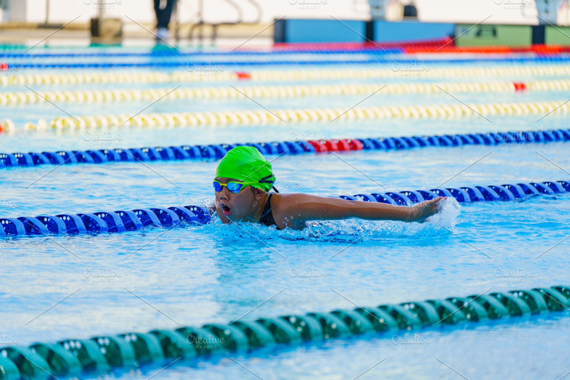 Swimmer child swims butterfly swimming style in a race swimming, a Sports & Recreation Photo by Casanowe-studio
