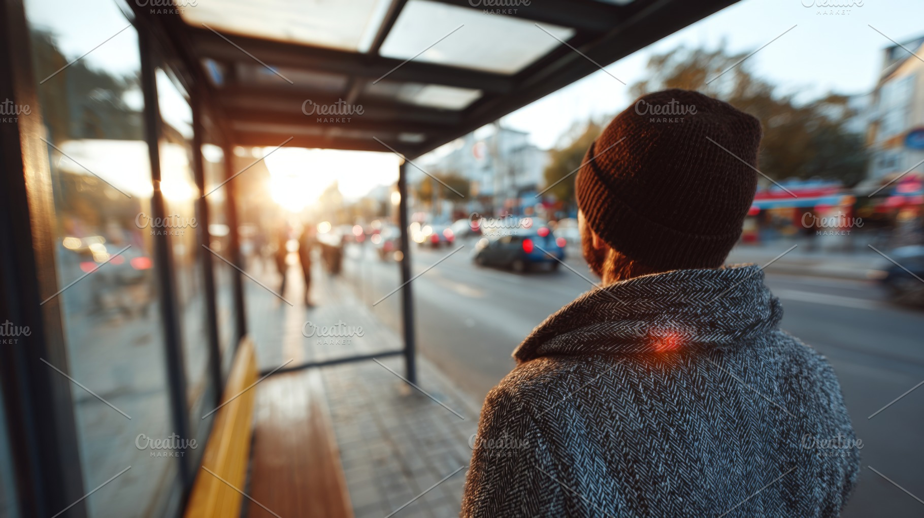 A man waits at a bus stop during sunset, wearing a warm beanie and a stylish co, a Person Photo by ImageMir