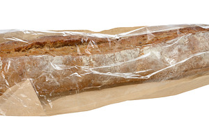 Crispy baguette in paper bag on isolated background, a Food & Drink Photo by ndanko