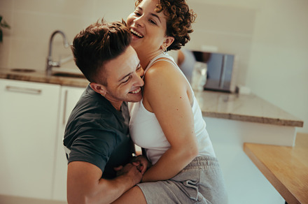 Romantic queer couple laughing in the kitchen, a Person Photo by Jacob Lund