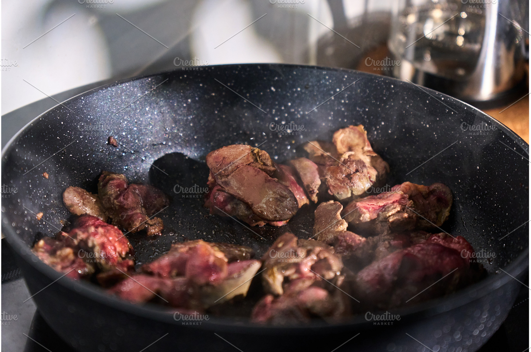 Sliced liver sizzles in a pan with, a Food & Drink Photo by darksoul72