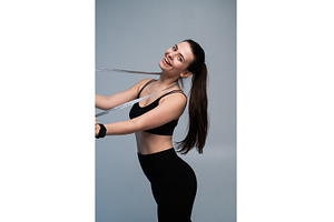 Happy young woman smiling, measuring, a Sports & Recreation Photo by volodymyrshtun13795