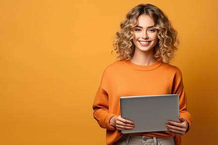 Young woman uses laptop or tablet, a, a Photo by Lopatin Photo