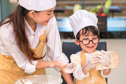 Beautiful woman and cute little Asian boy with eyeglasses, chef, a Person Photo by Ministocker