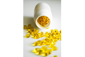 Yellow omega-3 capsules spread, a Health & Medical Photo by volodymyrshtun13795