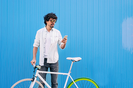 Young man with mobile and bicycle stock photo containing mobile and man, a Person Photo by nunezimage