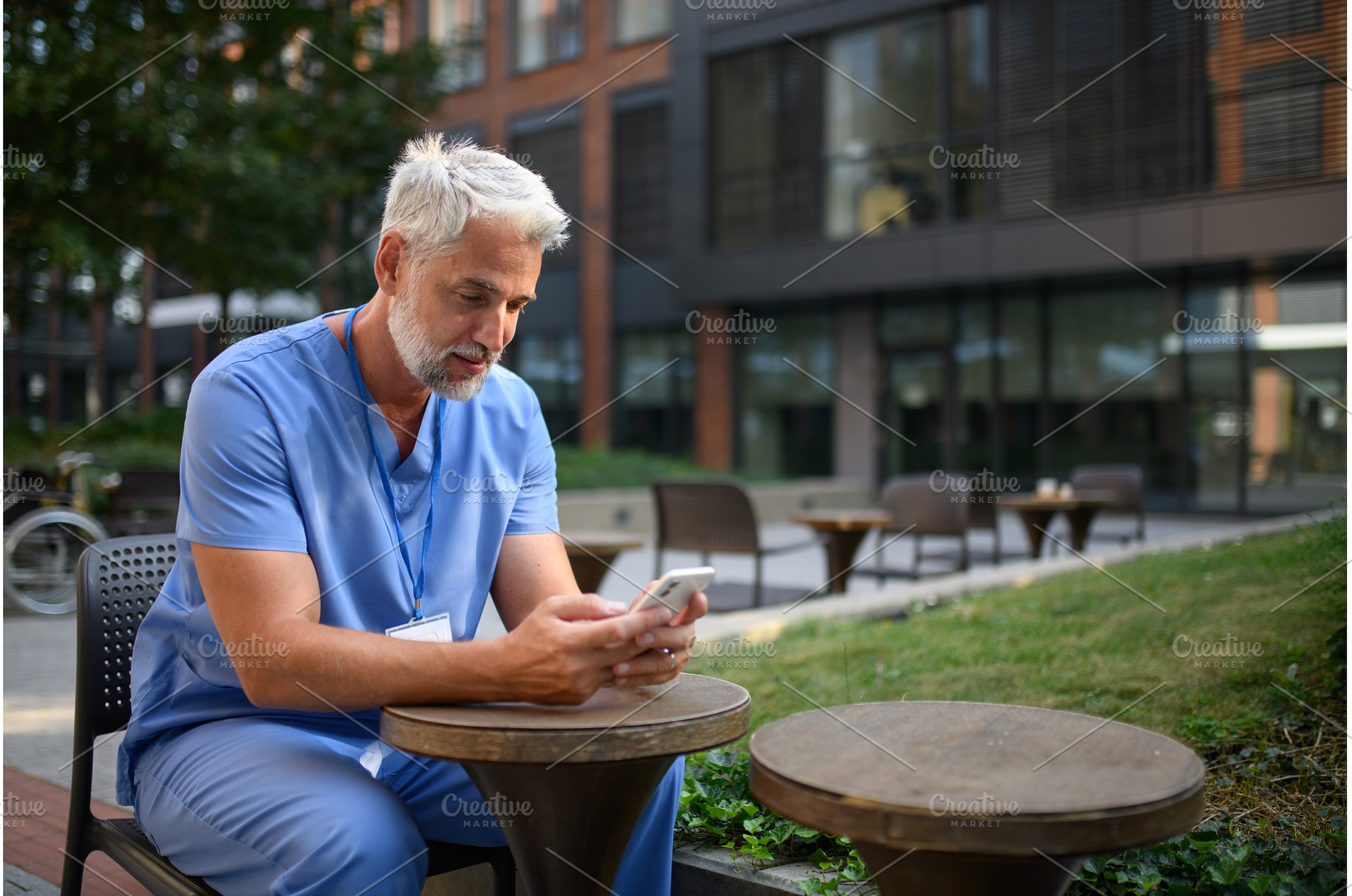 Healthcare worker outside hospital, a Health & Medical Photo by HalfPoint