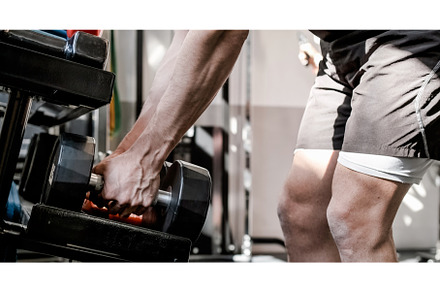 Crop man taking dumbbells from shelf, a Sports & Recreation Photo by Daniel Megias