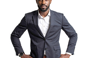 Black man standing in front of a neutral backdrop wearing a bold, a Person Photo by DanFLCreativo