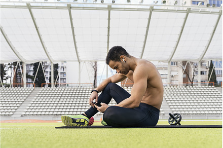 Side view of an Athlete Using Phone, a Person Photo by nunezimage
