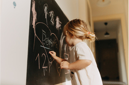 A little girl drawing on a, an Arts & Entertainment Photo by HalfPoint