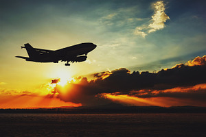 Silhouette of an airplane landing.