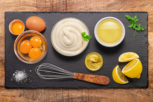 Homemade mayonnaise and mayo ingredients on black stone slate se, a Food & Drink Photo by Volff