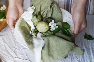 Happy Easter! Woman holding stylish eggs on linen napkin in plat, a Holiday Photo by Sonjachni