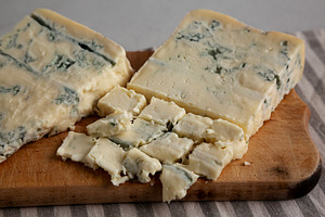 Blue cheese Gorgonzola on a Wooden Board, side view. Close-up., a Food & Drink Photo by LiudmylaChuhunova