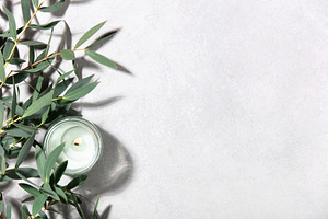 Eucalyptus Leaves and Scented Candle on Minimal Light Background