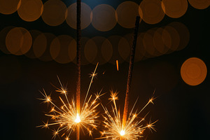 Sparklers glowing against bokeh ligh, a Photo by Dvoevnore photos