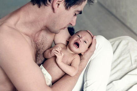 the father holds a newborn son