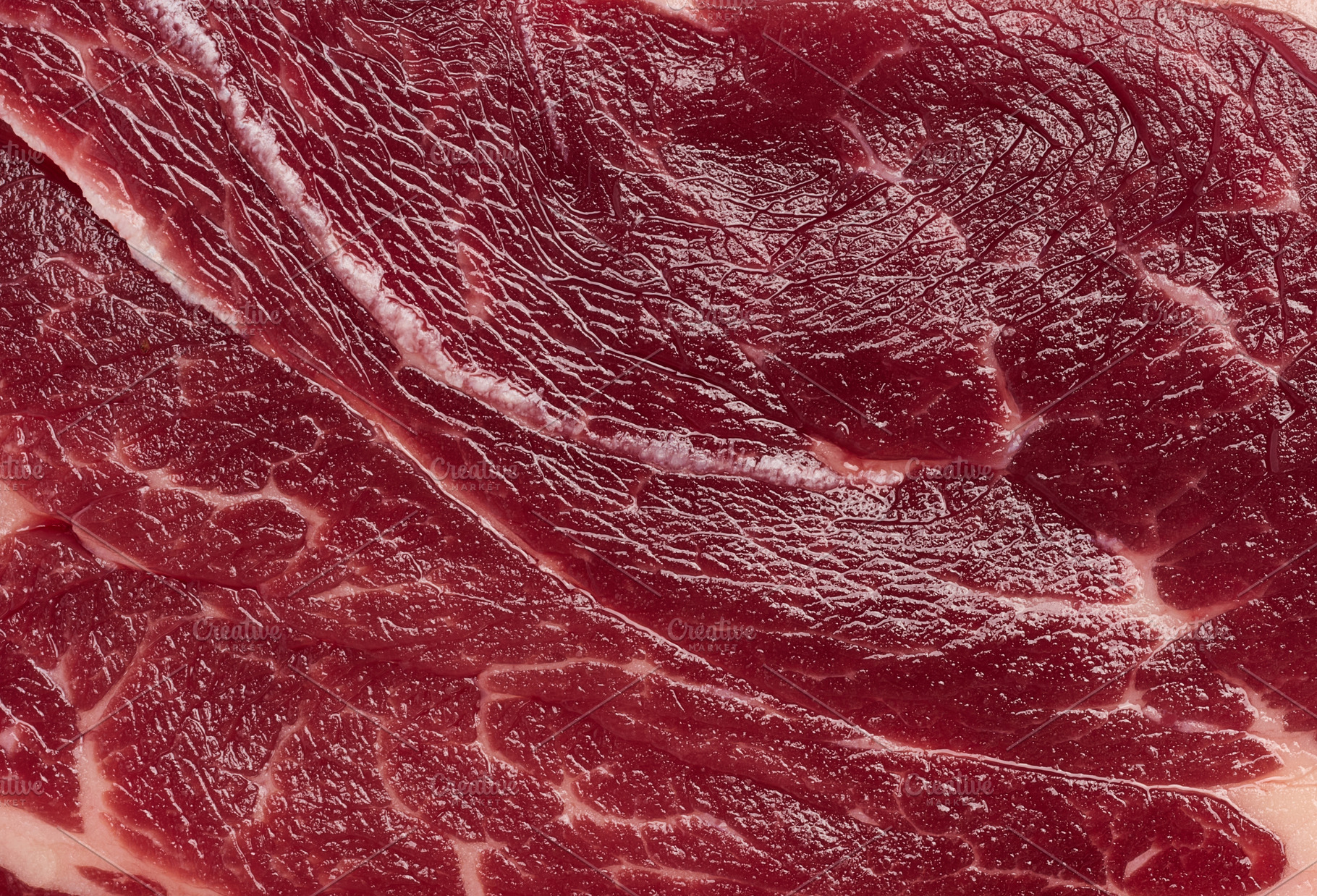 Detailed close up of fresh raw red meat texture with white fat m, a Food & Drink Photo by ndanko