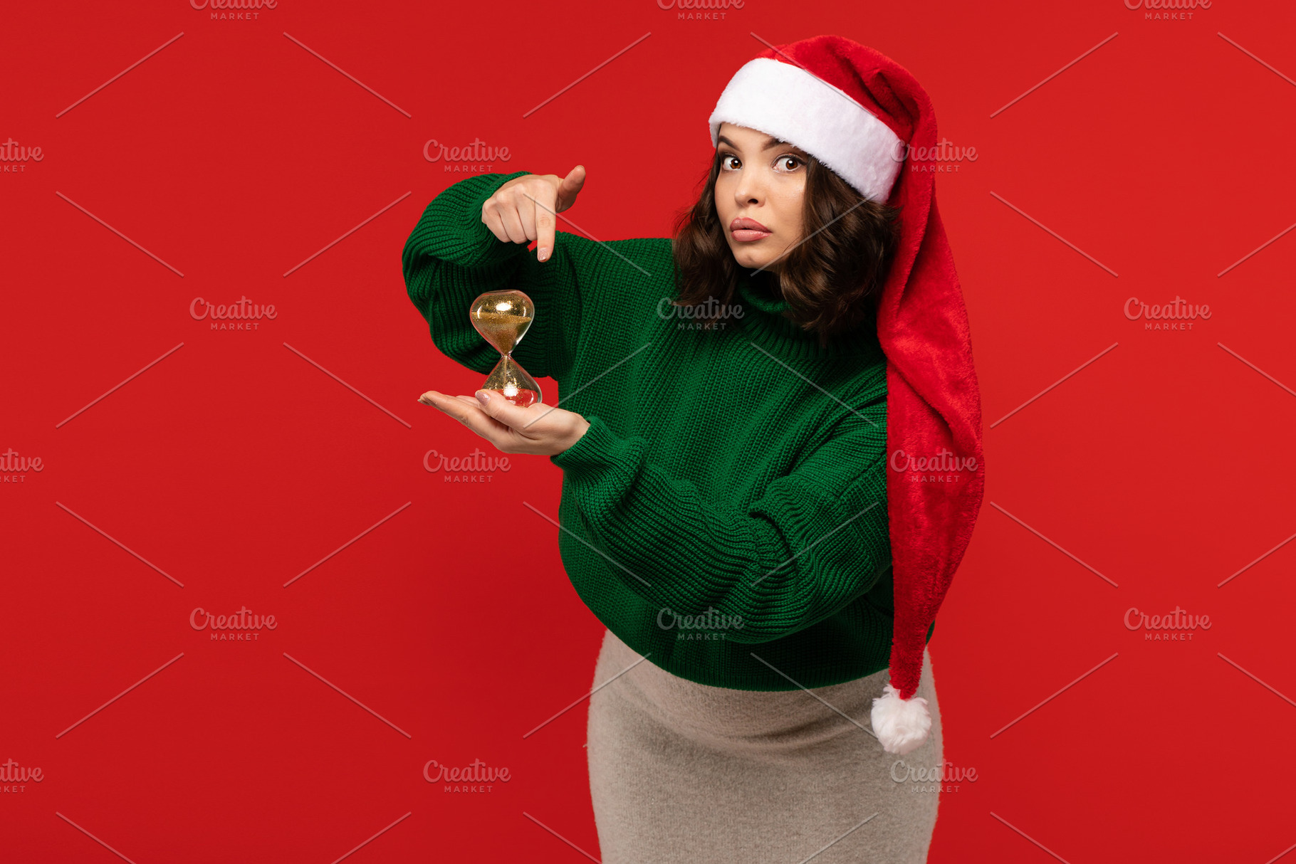 Serious woman in Santa hat pointing, a Holiday Photo by Elena Vagengeim