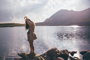 Young woman at a mountain lake