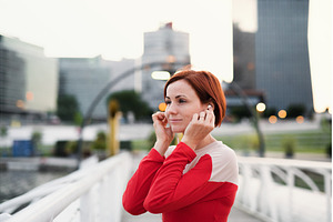 A young woman runner with earphones, a Person Photo by HalfPoint