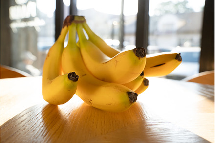 Bunch of bananas lying on the wooden, a Food & Drink Photo by oksix