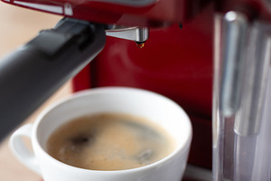 Fresh Espresso Coffee in White Cup Under Home Coffee Machine, a Person Photo by etorres69