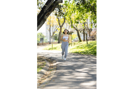 A woman is running on a path in a