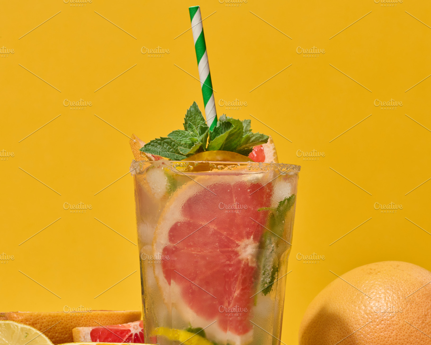 Top of clear glass with cold drink, grapefruit slices, ice and m, a Food & Drink Photo by ndanko