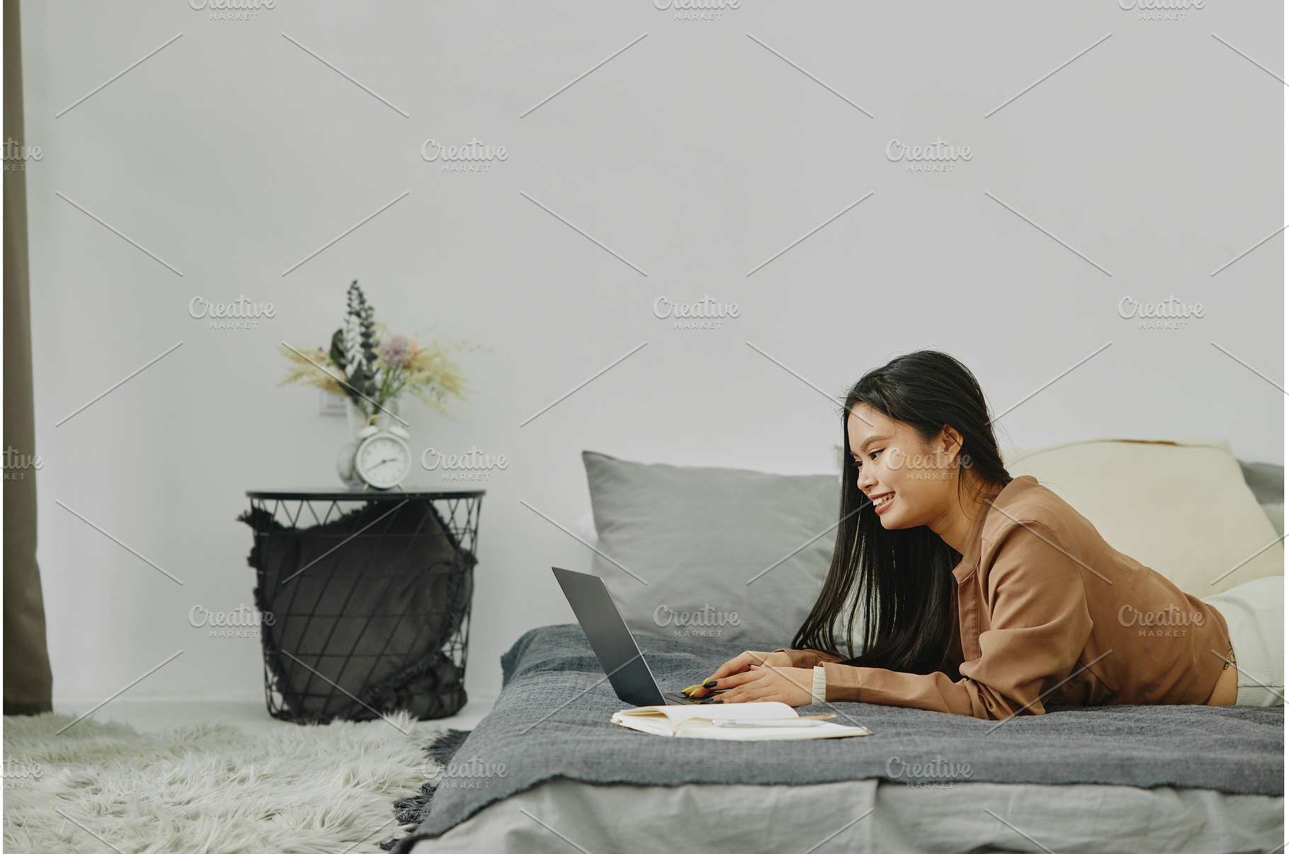 Young Asian woman lying on bed and, a Person Photo by Aliona Serzhanova