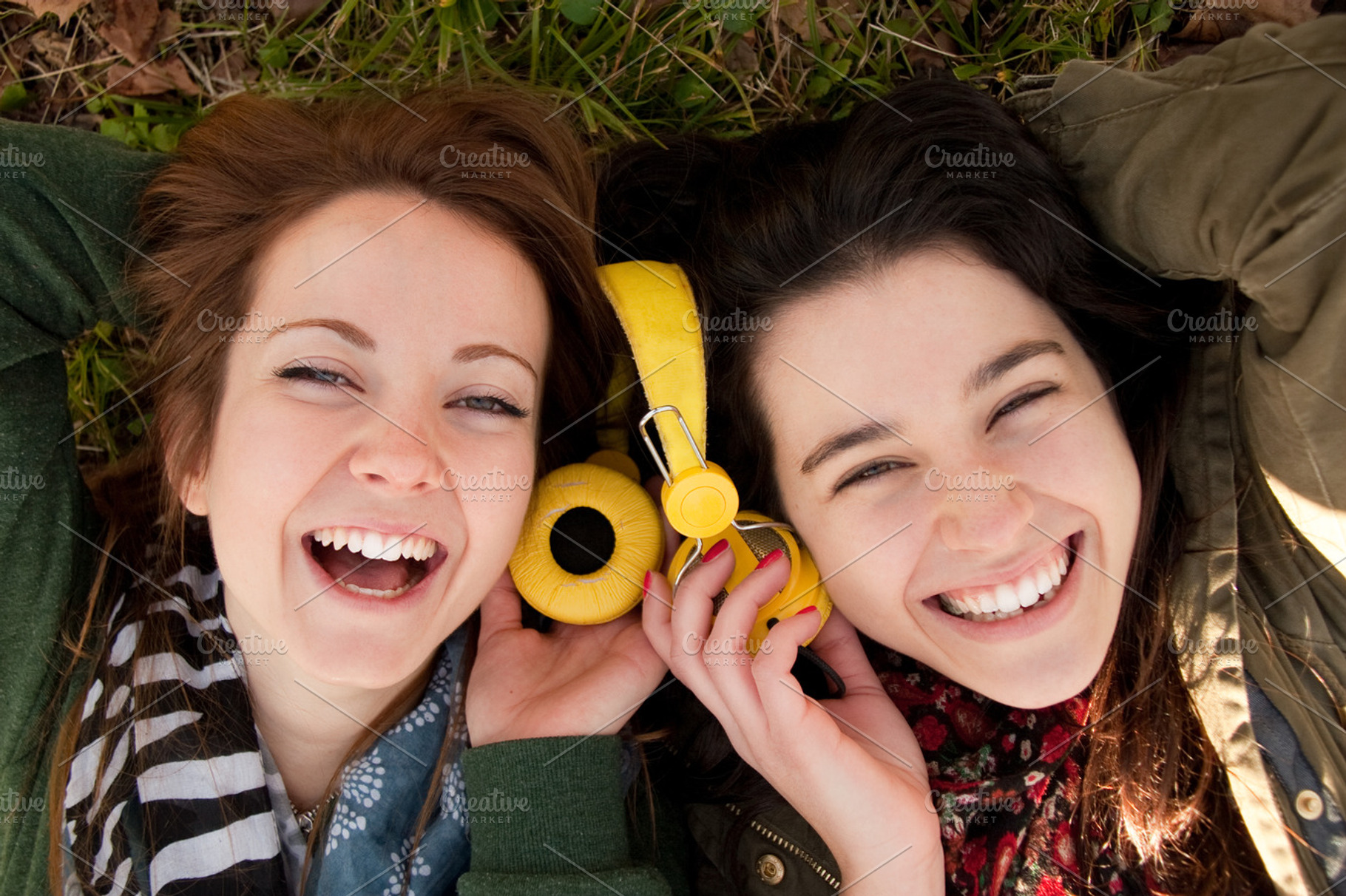 Happy teen girls sharing music, a Person Photo by asife