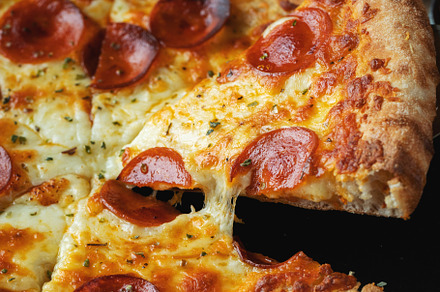 A slice of hot Italian pizza with stretching cheese. Pizza pepperoni on a dark, a Food & Drink Photo by Budarinphoto